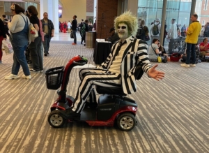 Convention attendee using an Indy Scooter Rentals mobility scooter in Indianapolis